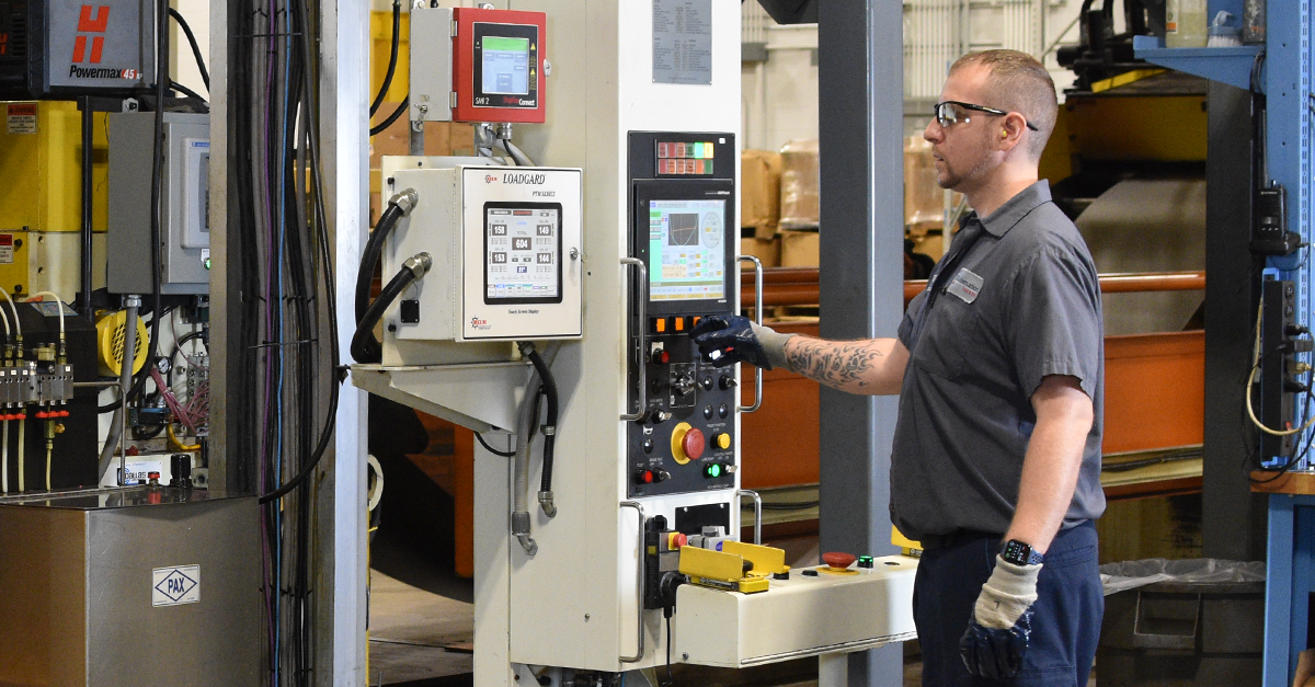 ATD technician operating advanced metal stamping equipment used in structural steel manufacturing for evolving industrial applications & future trends