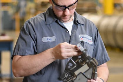 Employee josh inspecting a tool