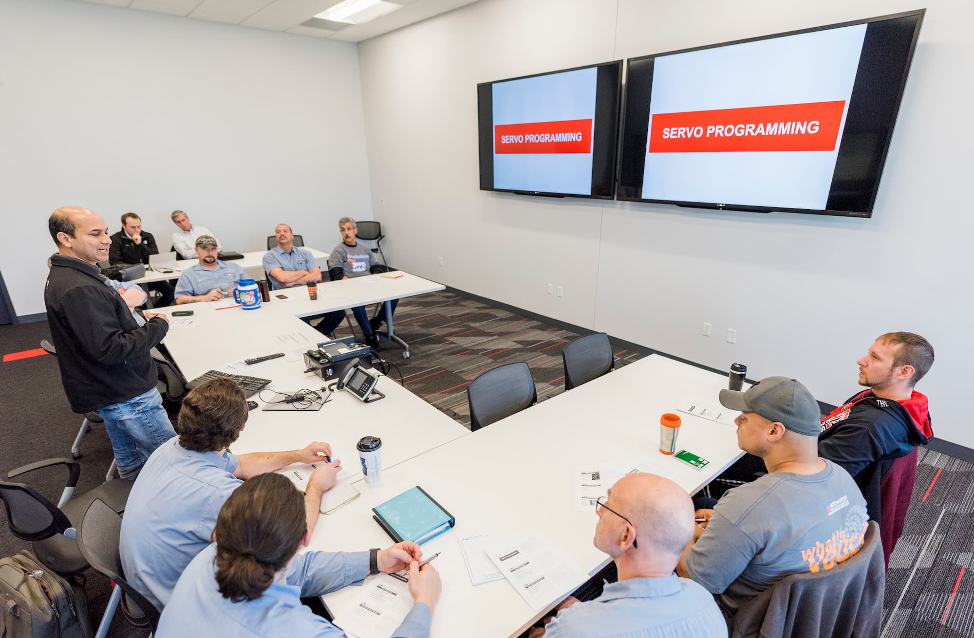 Employees around table discussing